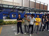 Workers gather at the entrance of the Foxconn complex