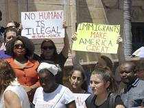 A group attends a rally to defend the Deferred Action for Childhood Arrivals (DACA) program in front of the MDC Freedom Tower in Miami