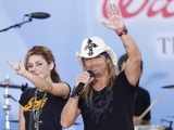 Miley Cyrus waves with Bret Michaels