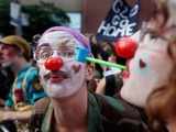 Demonstrators clown around while protesting