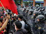 Police officers hold back the demonstrators