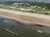 Crude oil washes up on the beach on Grand Isle