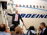 Boeing CEO Jim McNerney walks down aircraft stairs