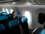 A Boeing employee sits next to a tinted window on the Boeing 787 Dreamliner