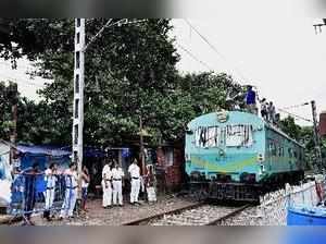 Kolkata: Railway workers inspect an overhead railway electrical line after devot...