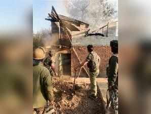 Srinagar: Security forces personnel dousing the fire at a slain PDP leader's hou...