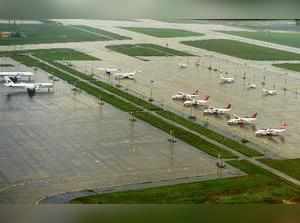Chennai: Aircrafts parked at a waterlogged area at the Chennai airport on Monday...