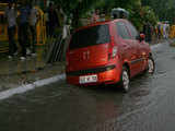 A vehicle gets stuck in a flooded street at ITO