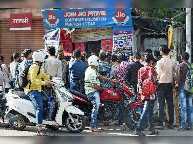 Mumbai: People crowd outside an outlet to buy the JIO mobile phone in Mumbai on ...