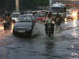 Vehicles wade through a flooded street