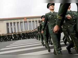 Chinese paramilitary policemen march outside the Great Hall of the People after ...