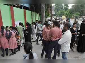 Moradabad: Students wait outside a centre to appear in CBSE's compartmental exam...