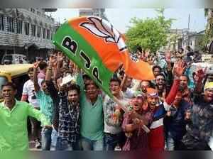 Agartala: BJP supporters wave party flag to celebrate BJP's win, which brought ...