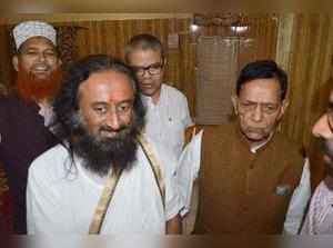 Faizabad: Spiritual leader Sri Sri Ravi Shankar with Haji Mahboob, a petitioner ...