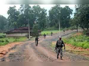 Latehar: CRPF personnel patrol a Maoist-affected village in Garu, Latehar on Wed...