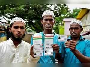 Chennai: Rohingya Muslim people showing their Aadhaar Cards at Kelambakkam in Ch...