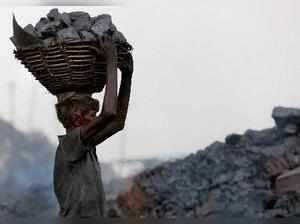 Dhanbad: A labourer carries coal on his head at Jharria and Digwadih area in Dha...