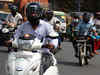 To get free helmet from cops, motorcyclists deliberately decide not to sport one