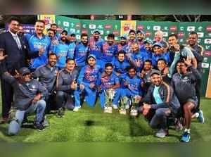 Cape Town : The Indian cricket team pose for a photo with their trophy after bea...