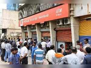 Navi Mumbai: Crowd gather after robbery at Bank of Baroda Juinagar branch in Nav...
