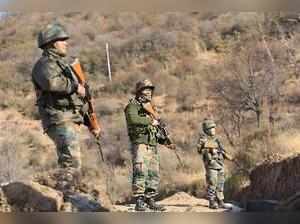 Rajouri: Army jawans take positions along LoC in Rajouri on Monday, a day after...