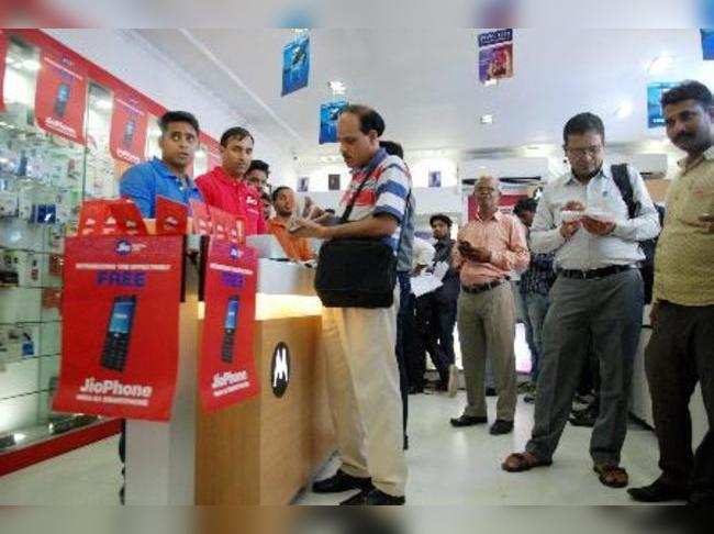New Delhi: People filling forms to buy JIO mobile phones in New Delhi on Thursda...