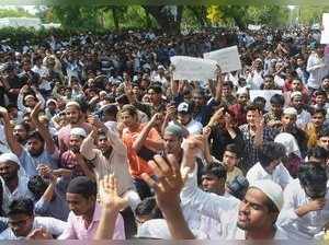 Aligarh: Aligarh Muslim University students stage a protest over Jinnah portrait...