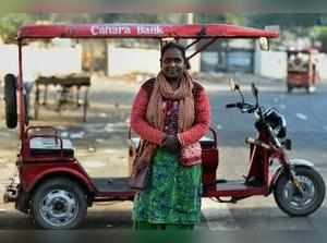 New Delhi: Binota (45), said to be Delhi's first female e-rickshaw driver, poses...