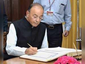 New Delhi: Union Finance Minister Arun Jaitley signs a register after taking oat...