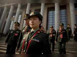 Beijing: Male and female Chinese military delegates walk down the steps of the G...