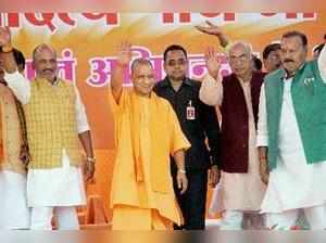 Azamgarh: Uttar Pradesh Chief Minister Yogi Adityanath waves at the crowd during...