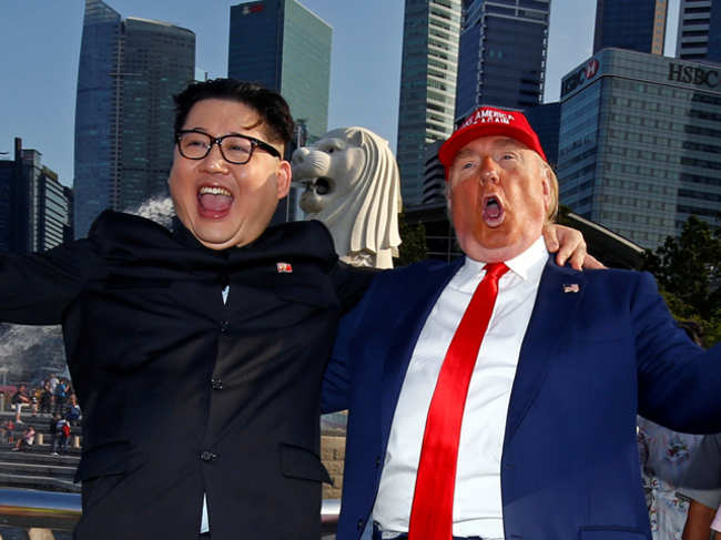 Howard, an Australian-Chinese impersonating North Korean leader Kim Jong-un, and Dennis Alan, impersonating U.S. President Donald Trump, meet at Merlion Park in Singapore
