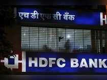A bird flies past a window of a HDFC Bank branch office in Mumbai