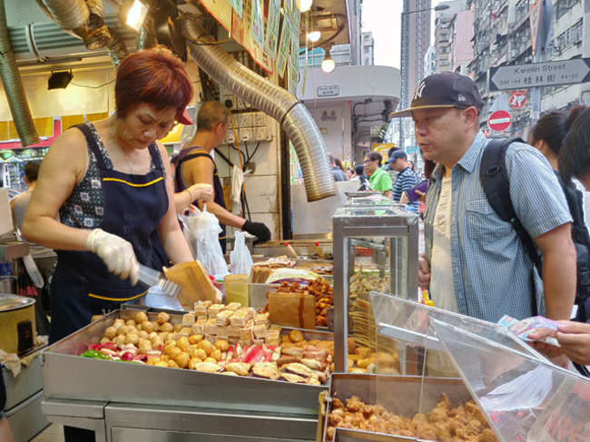​A typical busy street food stall​ in Hong Kong.