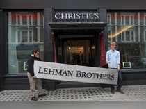 FILE PHOTO: Christie's employees pose for a photograph with a Lehman Brothers sign at Christie's in central London