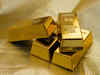Gold inches down as stronger dollar offsets weak stocks