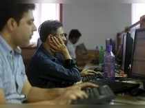 Brokers trade at their computer terminals at a stock brokerage firm in Mumbai