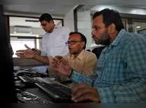 Brokers react while trading during the presentation of the federal budget at a stock brokerage firm in Mumbai