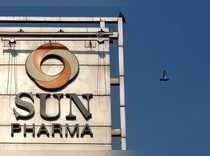 FILE PHOTO: A bird flies past the logo of Sun Pharma installed on the facade of its corporate office in Mumbai