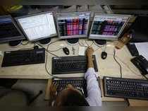 A broker monitors share prices while trading at a brokerage firm in Mumbai