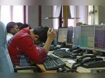 A broker reacts while trading at his computer terminal at a stock brokerage firm in Mumbai