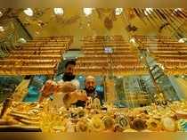 Goldsmiths arrange products in a gold and jewellery store in Istanbul