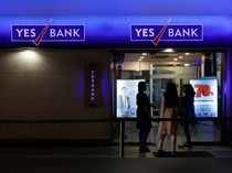 Employees enter a Yes Bank branch at its headquarters in Mumbai