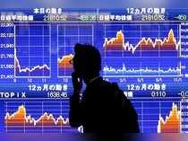A man looks at an electronic stock quotation board showing Japan's Nikkei average outside a brokerage in Tokyo
