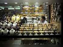A salesman is seen at his gold shop in Gold Souq in Dubai