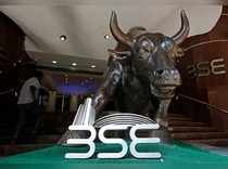 The Bombay Stock Exchange (BSE) logo is seen under a bull statue at the entrance of their building in Mumbai