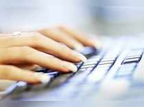 A woman uses a computer keyboard in this photo illustration taken in Sydney