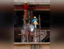 Gurugram: Labourers work at a construction site in Gurugram. Construction worker...