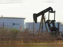 An oil pumpjack and a tank with the corporate logo of state oil company PDVSA are seen in an oil facility in Lagunillas