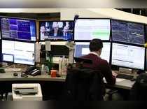 A trader works at his desk at the stock exchange in Frankfurt
